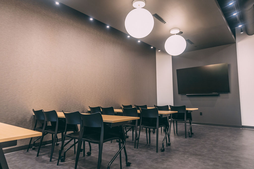 A modern conference room under circular pendant lights